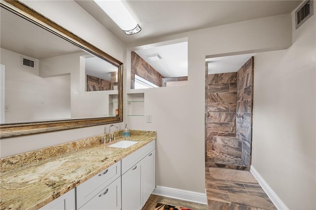 full bathroom featuring baseboards, visible vents, and walk in shower