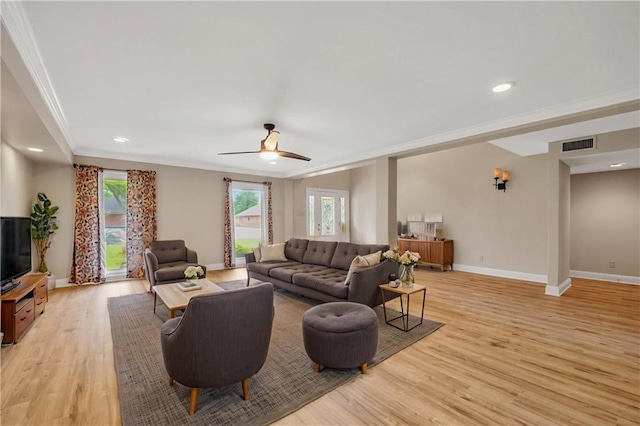 212 Somerset St, La Place, LA 70068 - living room featuring ornamental molding, light wood-style floors, baseboards, a ceiling fan, and plenty of natural light