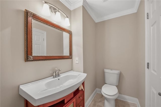 half bathroom with toilet, crown molding, vanity, and baseboards