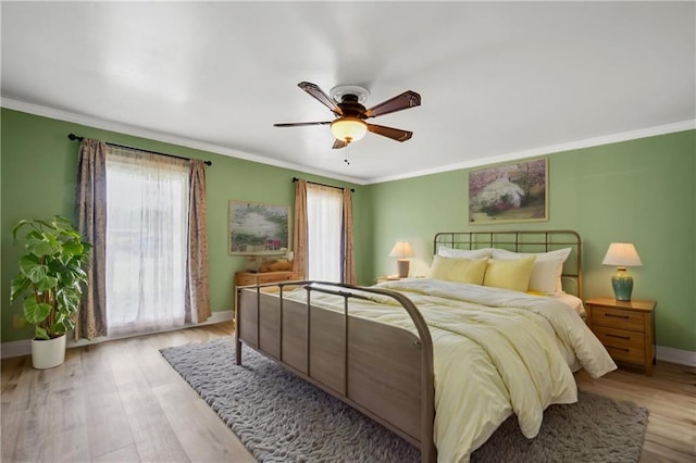 212 Somerset St, La Place, LA 70068 - bedroom featuring baseboards, crown molding, light wood-type flooring, and a ceiling fan