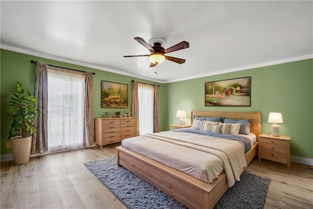 212 Somerset St, La Place, LA 70068 - bedroom featuring multiple windows, ornamental molding, wood finished floors, baseboards, and a ceiling fan