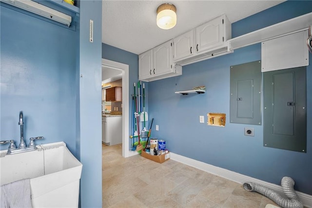 washroom featuring a sink, hookup for an electric dryer, hookup for a washing machine, and electric panel