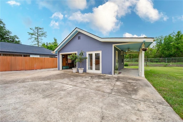 rear view of house featuring french doors, a ceiling fan, fence, and a lawn