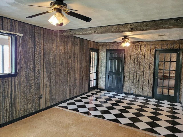 2745 Phil Ln, Marrero, LA 70072 - spare room with tile patterned floors, wooden walls, a ceiling fan, and healthy amount of natural light