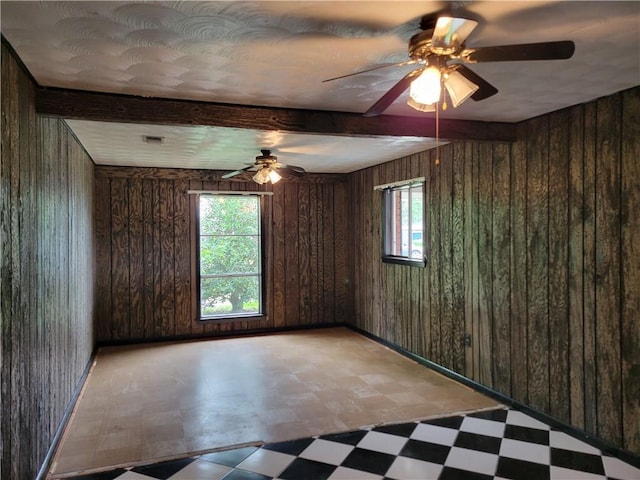 2745 Phil Ln, Marrero, LA 70072 - empty room with tile patterned floors, wooden walls, and a ceiling fan
