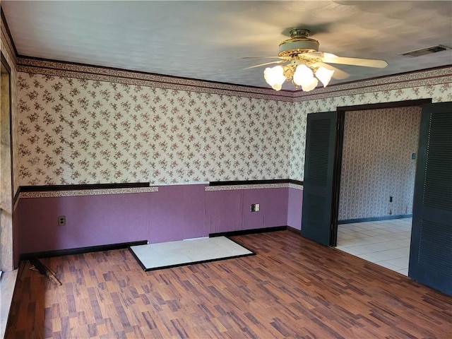 2745 Phil Ln, Marrero, LA 70072 - unfurnished room with wallpapered walls, ceiling fan, baseboards, and wood finished floors