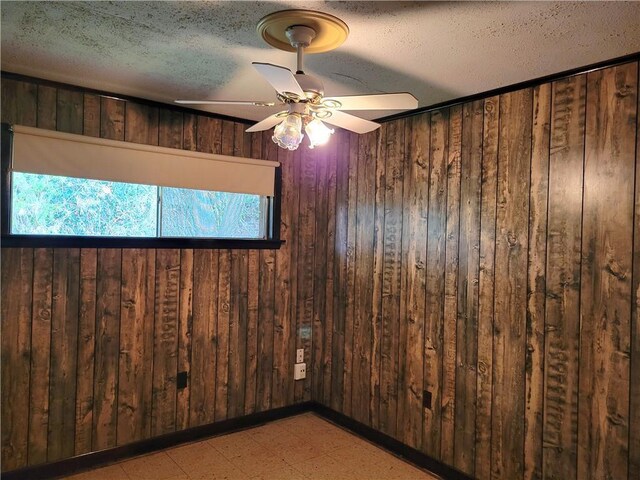 2745 Phil Ln, Marrero, LA 70072 - empty room featuring wooden walls, light flooring, a textured ceiling, and ceiling fan