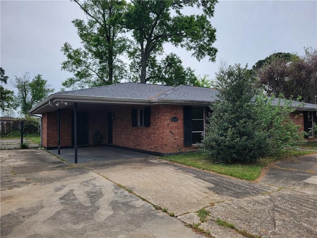 2745 Phil Ln, Marrero, LA 70072 - view of front of property with brick siding, asphalt driveway, a carport, and fence