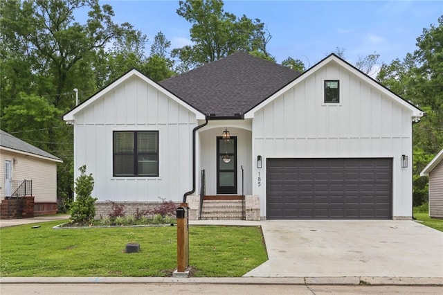 185 Boutte Estates Dr, Boutte, LA 70039 - modern farmhouse style home featuring an attached garage, concrete driveway, a front lawn, board and batten siding, and roof with shingles