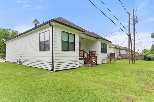 185 Boutte Estates Dr, Boutte, LA 70039 - exterior space with central air condition unit, a lawn, a shingled roof, and fence