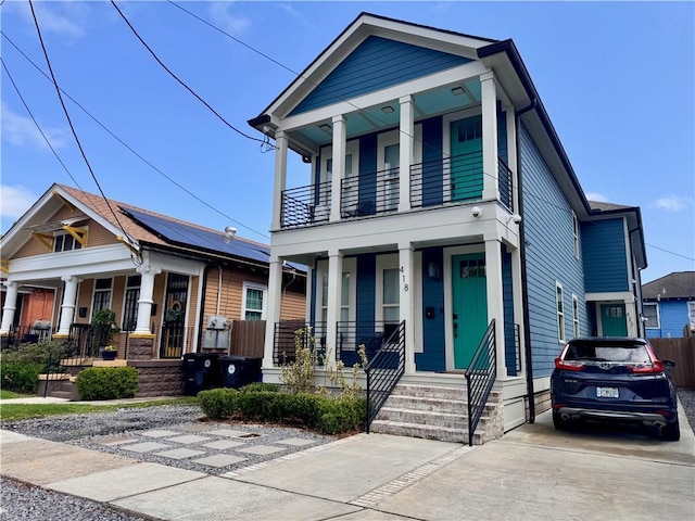 41820 S Genois St, New Orleans, LA 70119 - view of front of property with concrete driveway, a balcony, and covered porch