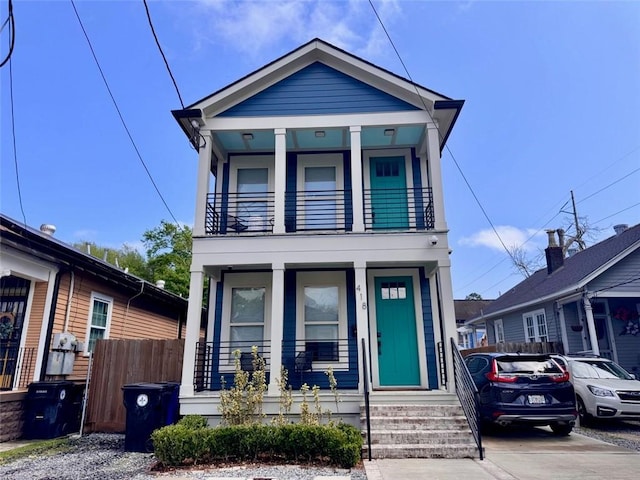 41820 S Genois St, New Orleans, LA 70119 - view of front of house featuring fence, covered porch, and a balcony