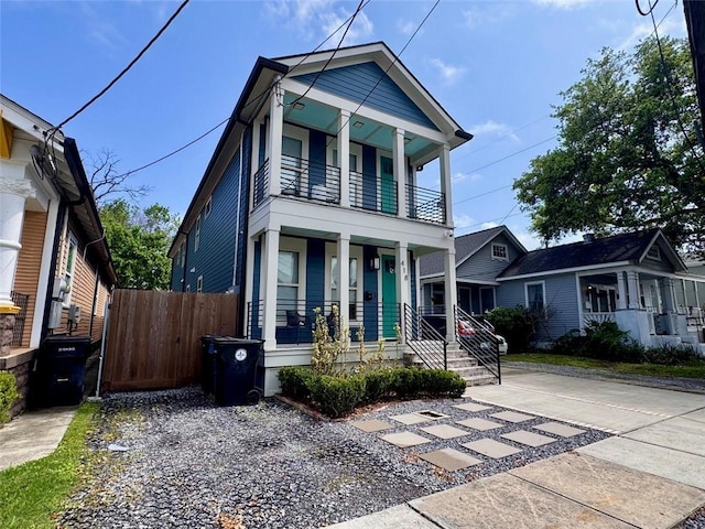 41820 S Genois St, New Orleans, LA 70119 - view of front of home featuring driveway, a balcony, fence, and covered porch