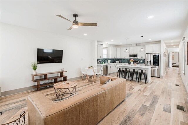 41820 S Genois St, New Orleans, LA 70119 - living room with visible vents, baseboards, ceiling fan, recessed lighting, and light wood finished floors