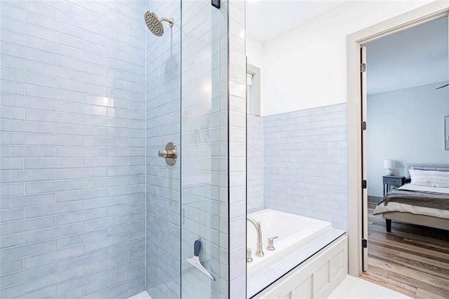 41820 S Genois St, New Orleans, LA 70119 - full bathroom featuring ensuite bath, a garden tub, a stall shower, and wood finished floors
