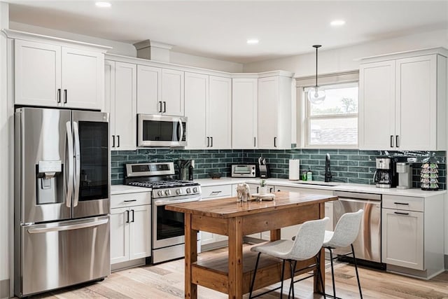 41820 S Genois St, New Orleans, LA 70119 - kitchen with decorative backsplash, light countertops, a sink, and appliances with stainless steel finishes