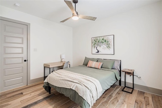 41820 S Genois St, New Orleans, LA 70119 - bedroom featuring baseboards, light wood finished floors, and ceiling fan