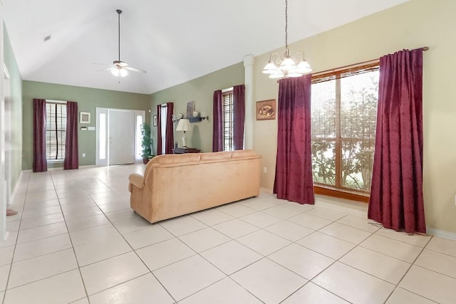 living area with light tile patterned floors, ceiling fan with notable chandelier, and vaulted ceiling