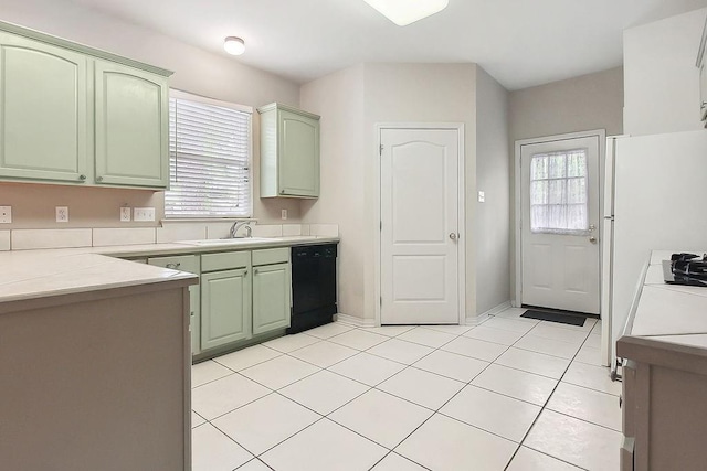 kitchen with green cabinetry, a wealth of natural light, dishwasher, and a sink