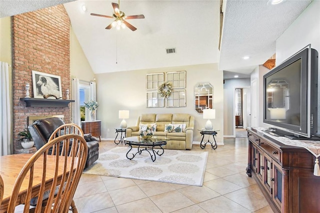living area with visible vents, a fireplace, a ceiling fan, light tile patterned floors, and baseboards