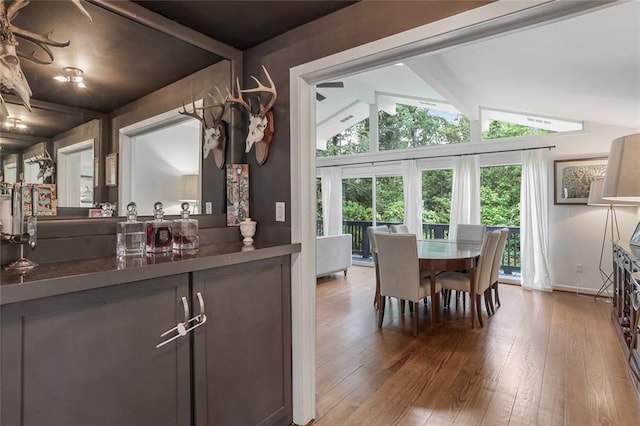 dining area with lofted ceiling and hardwood / wood-style floors