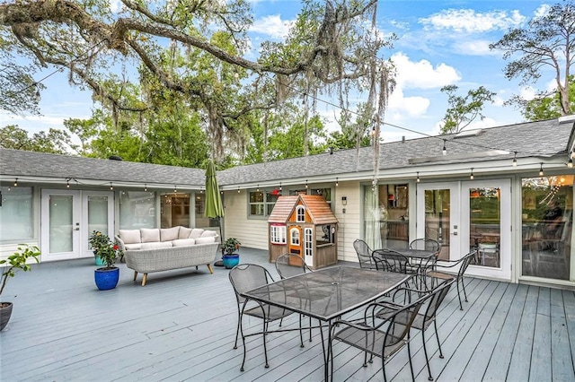 wooden deck with outdoor dining area, outdoor lounge area, and french doors