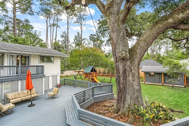 wooden deck with a lawn, fence, an outdoor structure, a playground, and outdoor lounge area