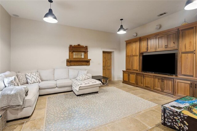 living area featuring visible vents and light tile patterned floors