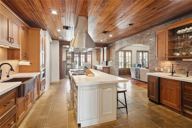 kitchen with plenty of natural light, a sink, and wooden ceiling