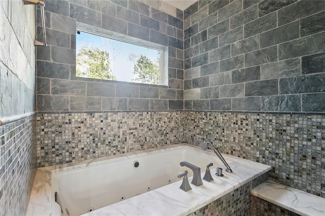 full bath with a jetted tub and tile walls