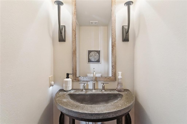 bathroom with visible vents and a sink