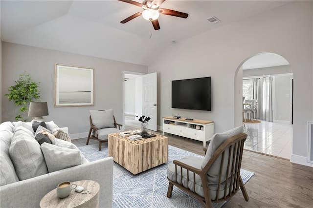21216 Gardenia St, Covington, LA 70435 - living area featuring arched walkways, a ceiling fan, lofted ceiling, and light wood-style floors