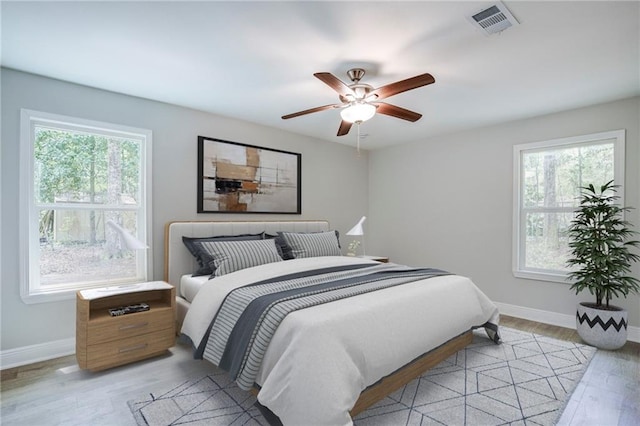 21216 Gardenia St, Covington, LA 70435 - bedroom featuring multiple windows, light wood finished floors, and a ceiling fan