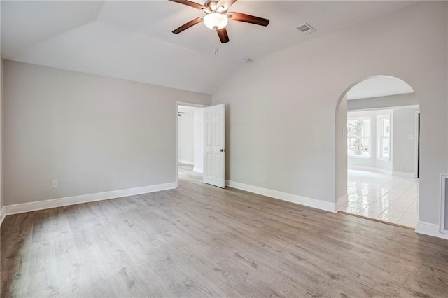 21216 Gardenia St, Covington, LA 70435 - unfurnished room featuring a ceiling fan, arched walkways, lofted ceiling, and wood finished floors
