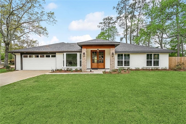 prairie-style house with brick siding, fence, a garage, french doors, and a front lawn