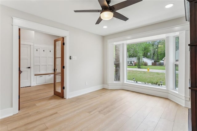 unfurnished room with baseboards, light wood-type flooring, ceiling fan, and recessed lighting