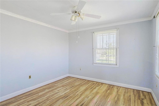 spare room featuring baseboards, ornamental molding, wood finished floors, and ceiling fan