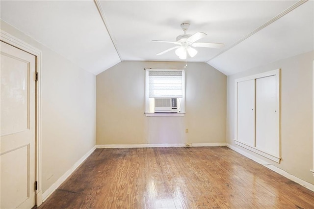 bonus room with baseboards, wood finished floors, vaulted ceiling, and a ceiling fan