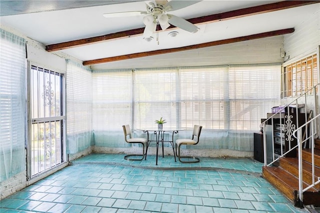 sunroom / solarium featuring beamed ceiling