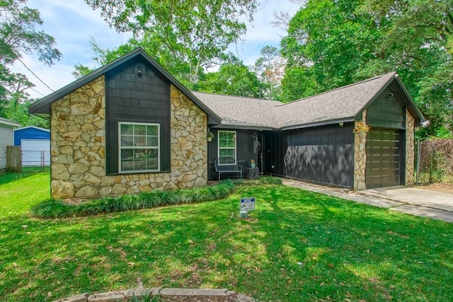 2523 Oriole St, Slidell, LA 70460 - view of front of home featuring stone siding, a garage, a shingled roof, and driveway