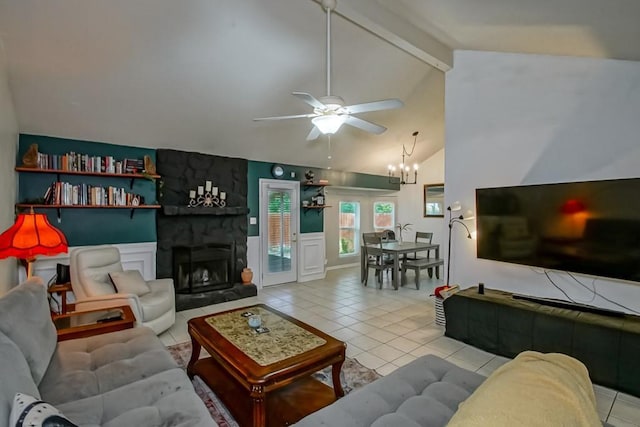 2523 Oriole St, Slidell, LA 70460 - living area featuring light tile patterned flooring, a ceiling fan, a stone fireplace, and a chandelier