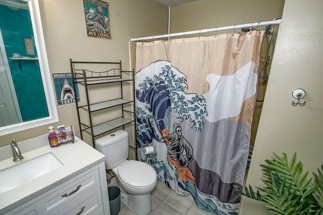 bathroom featuring vanity, a shower with shower curtain, tile patterned flooring, and toilet