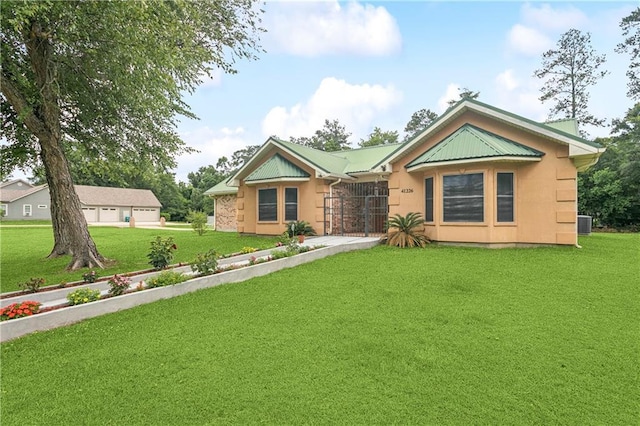 41226 Rene Dr, Hammond, LA 70403 - ranch-style home featuring a front yard, a garage, and stucco siding