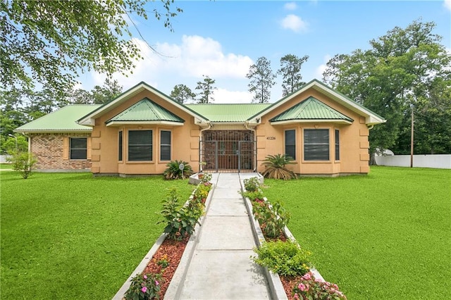 41226 Rene Dr, Hammond, LA 70403 - view of front of home featuring stucco siding and a metal roof