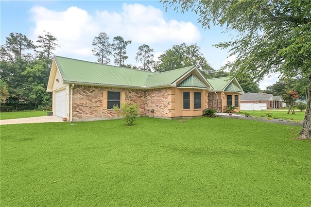 41226 Rene Dr, Hammond, LA 70403 - single story home featuring a front lawn, driveway, a metal roof, and an attached garage