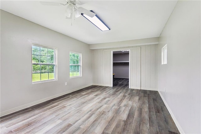 41226 Rene Dr, Hammond, LA 70403 - unfurnished bedroom featuring wood finished floors, ceiling fan, a closet, and a walk in closet