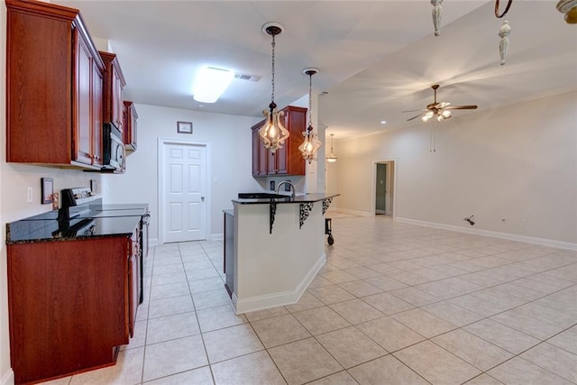 111 Cornerstone Dr Unit 1A, Slidell, LA 70461 - kitchen with range with electric stovetop, stainless steel microwave, open floor plan, light tile patterned floors, and a ceiling fan