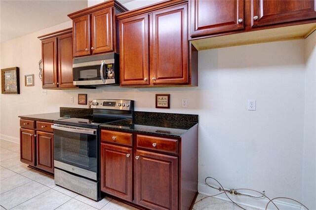 111 Cornerstone Dr Unit 1A, Slidell, LA 70461 - kitchen with stainless steel appliances, dark stone counters, and light tile patterned flooring