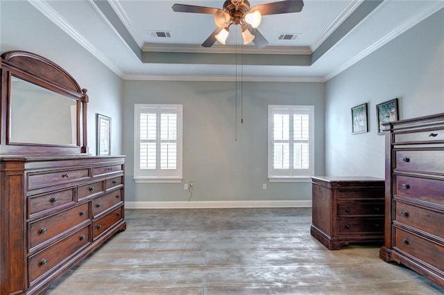 111 Cornerstone Dr Unit 1A, Slidell, LA 70461 - bedroom featuring a tray ceiling, multiple windows, light wood finished floors, and crown molding
