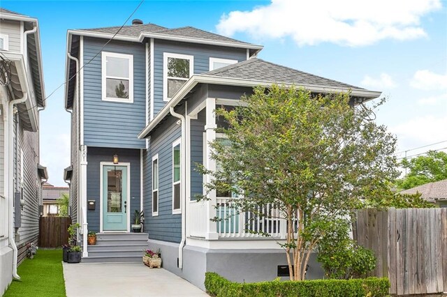 8501 Cohn St, New Orleans, LA 70118 - view of front of home featuring fence and roof with shingles